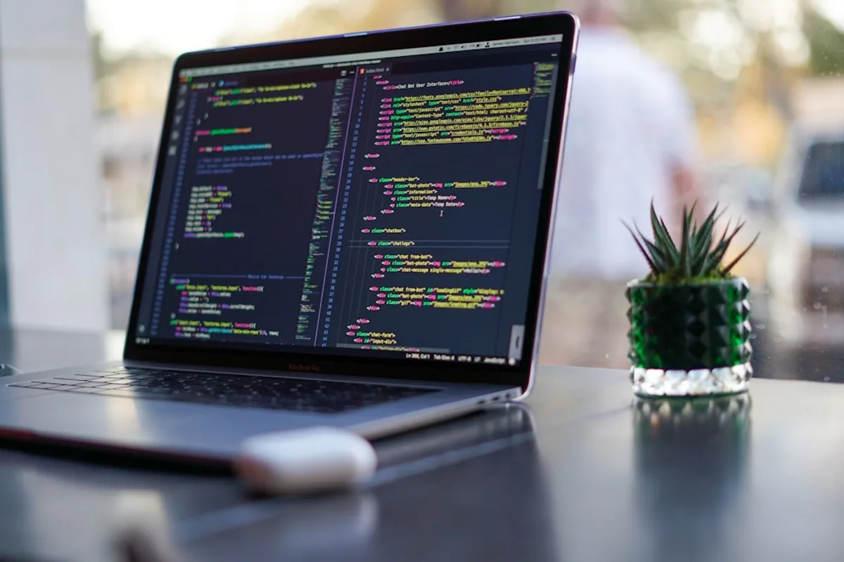 Laptop displaying a web development code editor